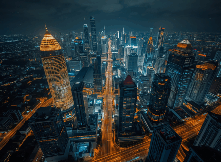 Pemandangan malam Jakarta dengan gedung pencakar langit modern dan lampu kota berkilau.